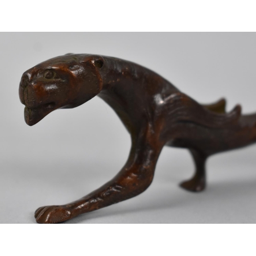 123 - A Patinated Bronze Brush/Pen Stand in the Form of an Elongated Winged Lion, 18cms Long