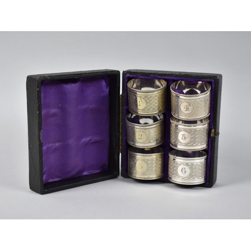 129 - A Cased and Numbered set of Six Silver Plated Napkin Rings together with a Cased Set Comprising Eggc... 