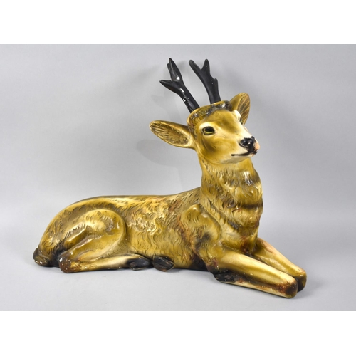 141 - A 1950's Cold Painted Plaster Study of a Reclining Stag, 42cms Long