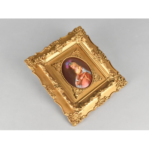 149 - A Gilt Framed Oval Painted Porcelain Panel Depicting Seated Maiden with hat, 9cms High