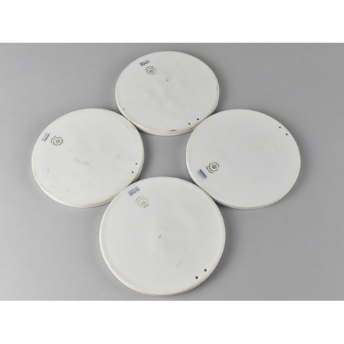 168 - A Set of Four Royal Copenhagen Circular Bisque Plaques, 13.5cms Diameter