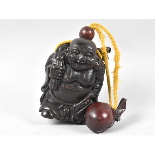 169 - A Reproduction Carved Wooden Inro in the Form of a Smiling Elder with Netsuke in the form of a Sack