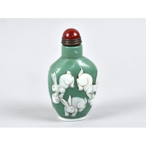 294 - A Reproduction Chinese Overlaid Snuff Bottle Decorated with Dragon and Bat, 8.5cm high