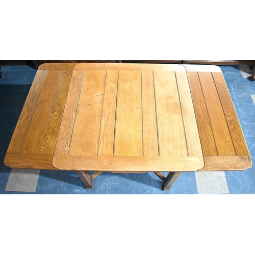 535 - An Edwardian Oak Draw Leaf Dining Table, Extends to 152cms by 91cms