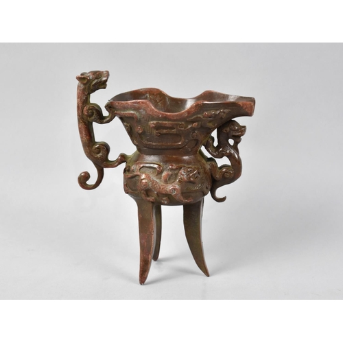 62 - A Reproduction Patinated Bronze Ewer of Archaic Form with Lion Handle and Three Feet, 13cms High