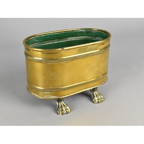 99 - An Oval Brass Container with Four Claw Feet, 14cms Wide