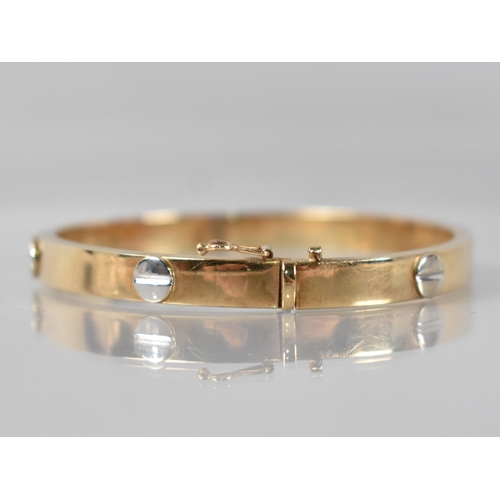 78 - A 9ct Gold Hinged Bracelet having White Metal Raised Stylised Screw Head Embellishments in the Round... 