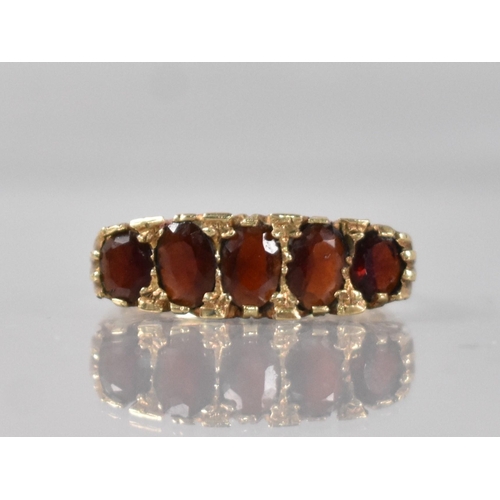 30 - A 9ct Gold and Garnet Boat Ring, Graduated Mixed Oval Cut Stones with Largest Measuring 5.1mm by 4.2... 