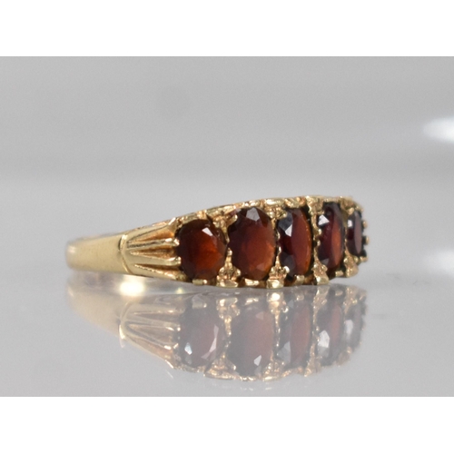 30 - A 9ct Gold and Garnet Boat Ring, Graduated Mixed Oval Cut Stones with Largest Measuring 5.1mm by 4.2... 