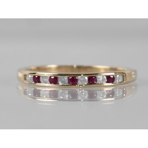 33 - A 9ct Gold, Diamond and Ruby Ring, Eleven Channel Set Round Cut Stones Comprising Six Diamonds (Tota... 