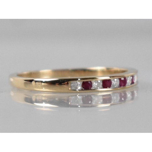 33 - A 9ct Gold, Diamond and Ruby Ring, Eleven Channel Set Round Cut Stones Comprising Six Diamonds (Tota... 