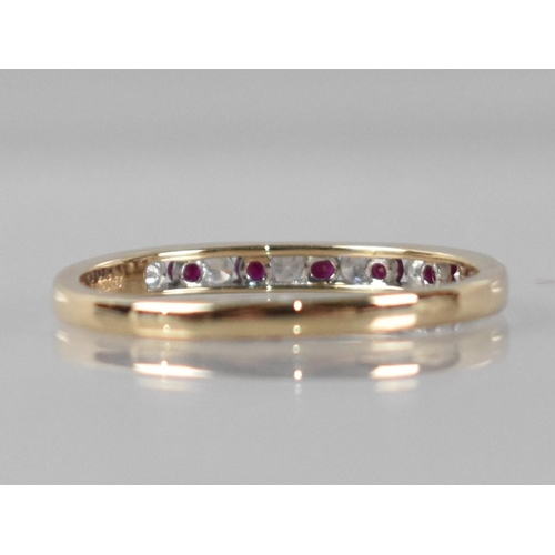 33 - A 9ct Gold, Diamond and Ruby Ring, Eleven Channel Set Round Cut Stones Comprising Six Diamonds (Tota... 