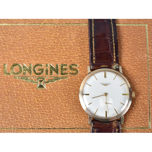 2 - A Late 1950s or Early 1960s Gold Coloured Metal Cased Longines Wristwatch, Champagne Dial with Baton... 