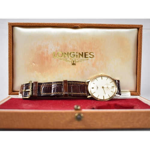 2 - A Late 1950s or Early 1960s Gold Coloured Metal Cased Longines Wristwatch, Champagne Dial with Baton... 