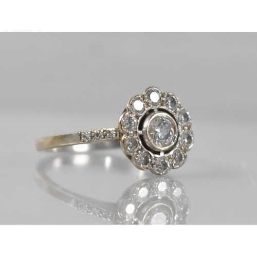 24 - A Diamond Daisy Ring, Central Round Cut Stone 3.9mm Diameter Approx, Bezel Set in White Metal and wi... 