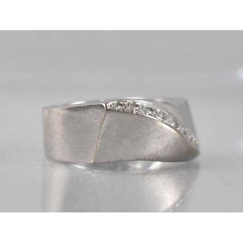 26 - An 18ct White Gold and Diamond Ring, Contemporary Wave Form with Recessed Band of Ten Small Round Br... 