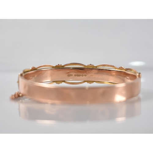 129 - A 9ct Rose Gold Hinged Bangle having Engraved Floral Decoration to Front and Pierced Decoration to E... 