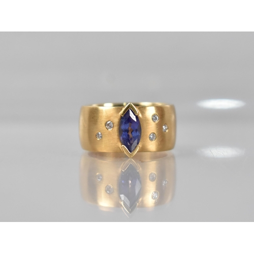 25 - A Contemporary 18ct Gold, Diamond and Tanzanite Ring, Central Marquise Cut Stone Measuring 5.02 by 9... 