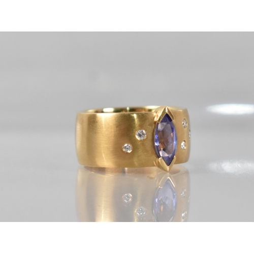 25 - A Contemporary 18ct Gold, Diamond and Tanzanite Ring, Central Marquise Cut Stone Measuring 5.02 by 9... 