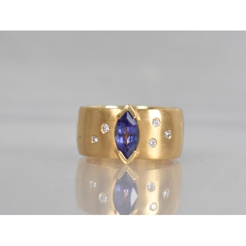 25 - A Contemporary 18ct Gold, Diamond and Tanzanite Ring, Central Marquise Cut Stone Measuring 5.02 by 9... 