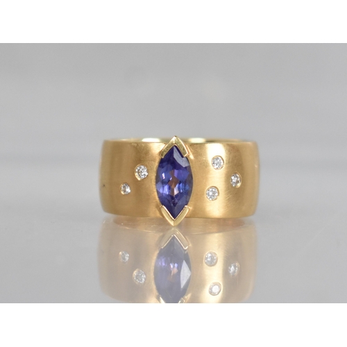 25 - A Contemporary 18ct Gold, Diamond and Tanzanite Ring, Central Marquise Cut Stone Measuring 5.02 by 9... 