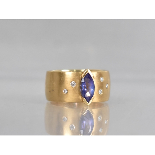 25 - A Contemporary 18ct Gold, Diamond and Tanzanite Ring, Central Marquise Cut Stone Measuring 5.02 by 9... 