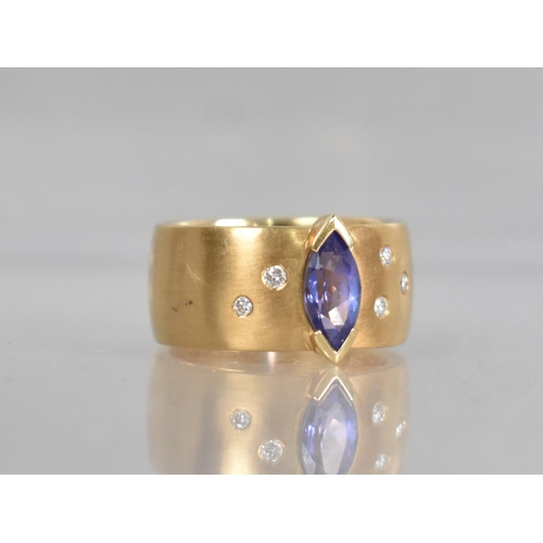 25 - A Contemporary 18ct Gold, Diamond and Tanzanite Ring, Central Marquise Cut Stone Measuring 5.02 by 9... 