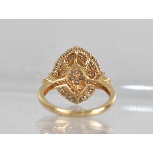 56 - A 9ct Gold and Diamond Cocktail Ring, Central Raised Lozenge With Nine Small Round Cut Diamonds Held... 