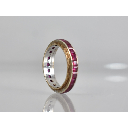 58 - An Early 20th Century Ruby Eternity Ring, Channel Set, Mixed Step Cut Stones Each Measuring Approx 2... 