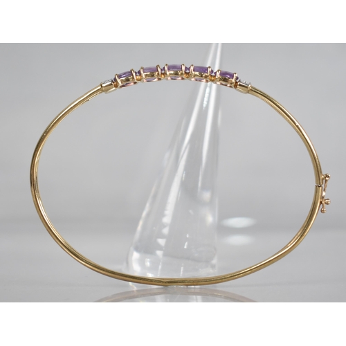 135 - A 9ct Gold Gem Set Bangle, Five Oval Cut Amethysts, Each Measuring 6.3mm by 4.2mm Set in Four Claws ... 