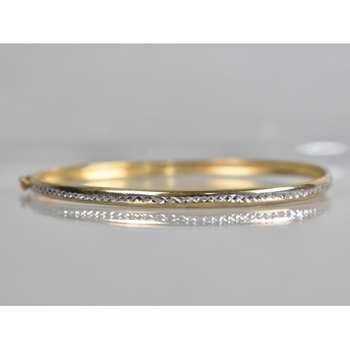 137 - A 9ct Gold Two Tone Bangle having Central Channel with Etched White Metal Decoration, Stamped to the... 