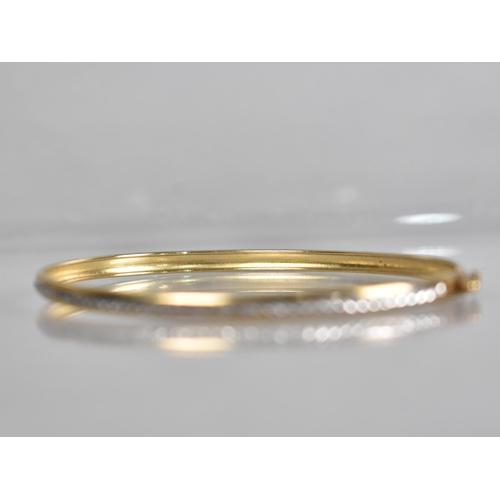 137 - A 9ct Gold Two Tone Bangle having Central Channel with Etched White Metal Decoration, Stamped to the... 