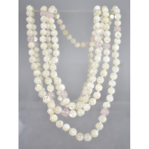 139 - A Very Long String of Spherical Mother of Pearl Beads having Rose Quartz Bead Embellishments, Each B... 