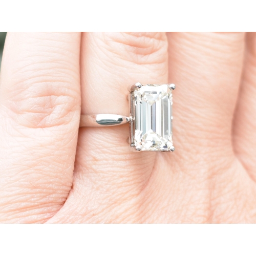 27 - A Diamond Solitaire Ring, Emerald Cut Stone Weighing 4.57cts with Measurements 12.44mm by 8.01mm by ... 