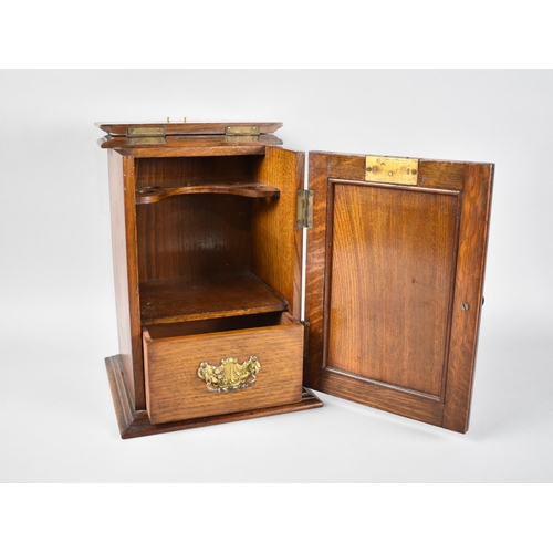 10 - An Art Nouveau Oak Smokers Cabinet, the Panelled Door with Metal Inset Having Relief Decoration, Bas... 