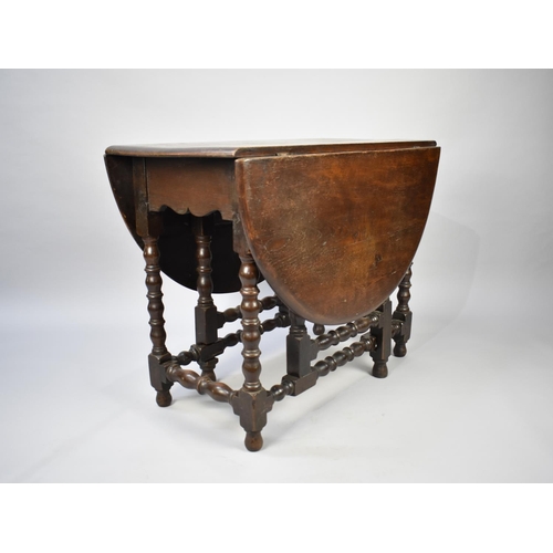 113 - A Mid 20th Century Oak Drop Leaf Gate Leg Table with Oval Top and Bobbin Supports, 97cm long