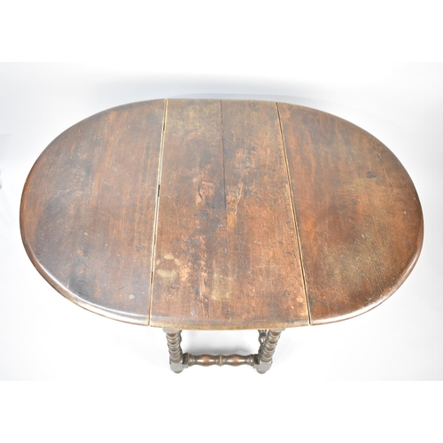 113 - A Mid 20th Century Oak Drop Leaf Gate Leg Table with Oval Top and Bobbin Supports, 97cm long