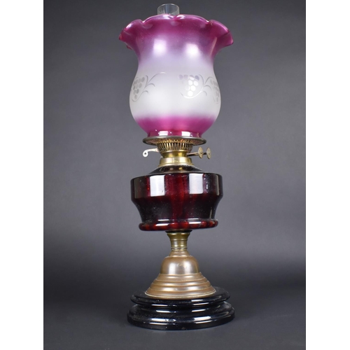 33 - A Late Victorian Brass Based Oil Lamp with Ruby Glass Reservoir and Later Coloured and Etched Shade,... 