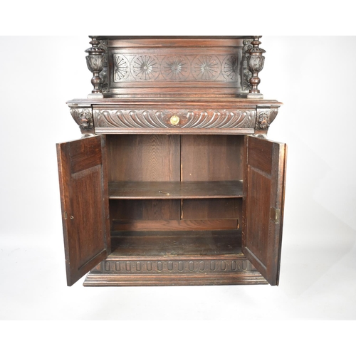 457 - A Continental Oak Side Cabinet with Raised Gallery Top, Carved Bulbous Supports and Carved Panel Doo... 