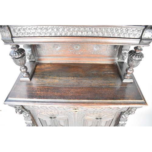 457 - A Continental Oak Side Cabinet with Raised Gallery Top, Carved Bulbous Supports and Carved Panel Doo... 