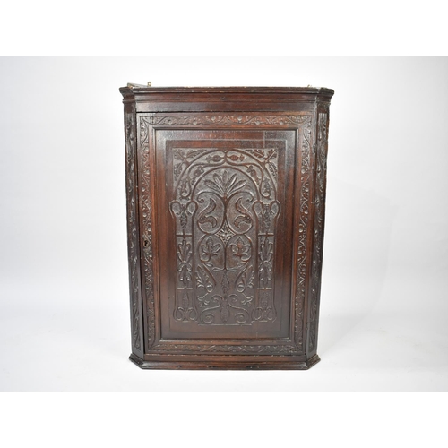 461 - A 19th Century Carved Oak Wall Hanging Corner Cabinet with Three Shaped Inner Shelves, 70cm wide and... 