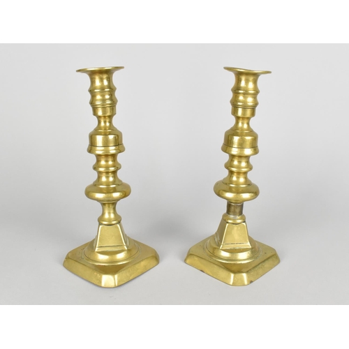 76 - A Pair of Victorian Brass Candlesticks with Pushers, 22.5cm High