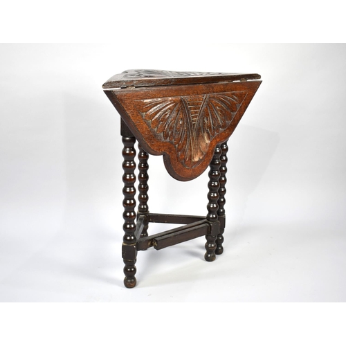 87 - A Late Victorian/Edwardian Drop Leaf Oak Occasional Table with Carved Top and Bobbin Tripod Supports... 