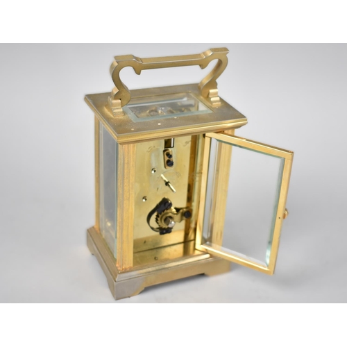 12 - A Mid 20th Century Brass Cased Carriage Clock, the White Enamel Dial inscribed Messell and Hilton, H... 