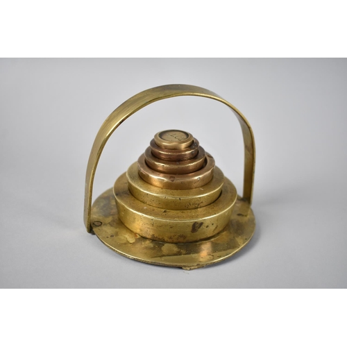 17 - A Set of Six Graduated Brass Weights on Circular Carrying Stand, 10cm High