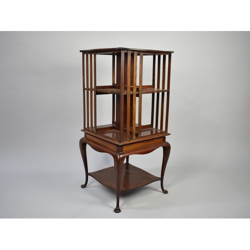 22 - A Small Edwardian Mahogany Revolving Bookcase on Cabriole Supports, 86cm High and 40cm Square