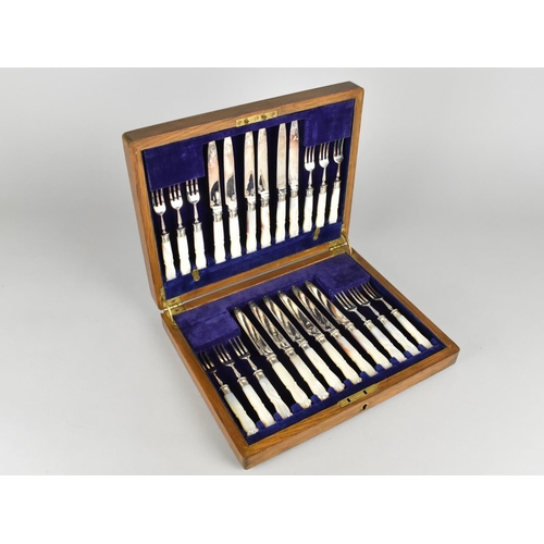 28 - A Late Victorian/Edwardian Oak Cased Set of Twelve Mother of Pearl Handle Fruit Knives and Forks wit... 