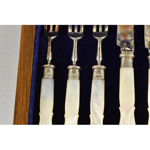 28 - A Late Victorian/Edwardian Oak Cased Set of Twelve Mother of Pearl Handle Fruit Knives and Forks wit... 