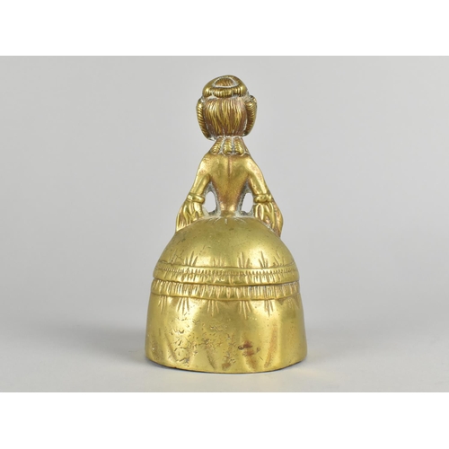 34 - A Heavy Brass Figural Table Bell in the Form of a Crinoline lady, 16cm High