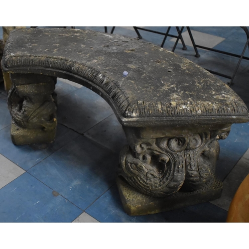 420 - A Reconstituted Stone Garden Crescent Shaped Bench with Moulded Dolphin Supports, 106cm Wide